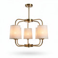 Modern brass chandelier with fabric shades suitable for dining areas
